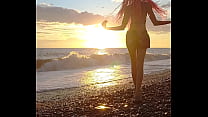 Sunset girl at the sea beach