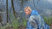A blonde babe wearing only a plastic raincoat caught by two men in masks in the woods