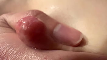 Female breast milk and nipple close up