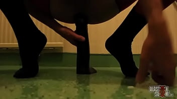 Sissy wearing pantyhose is riding a huge black dildo