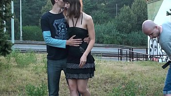 A very pretty young girl public threesome sex fucking in the middle of a street with 2 guys with big cocks with oral sex sucking dicks and vaginal pussy fuck in turn while all the drivers and people who walks on a street watch them doing that with passion  
