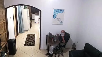 While the husband works, the wife in a towel greets the delivery man.