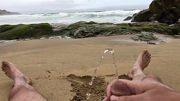 thumb self pee at a n  ude beach  