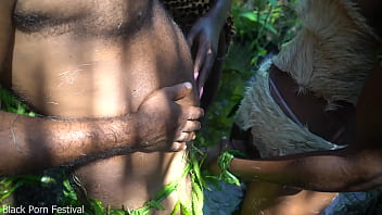 2 African tribe girl having fun with the village chief in the middle of the forrest
