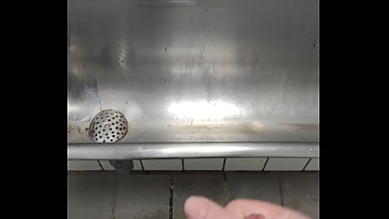 Young hard cock sprays at urinal