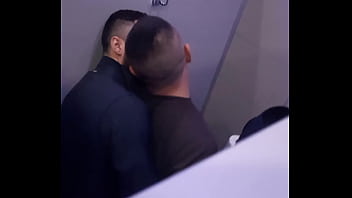 2 men having fun in a public toilet