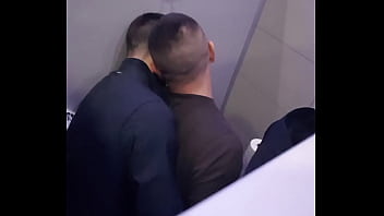 2 men having fun in a public toilet