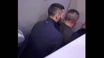 2 men having fun in a public toilet