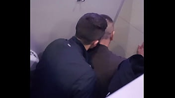 2 men having fun in a public toilet