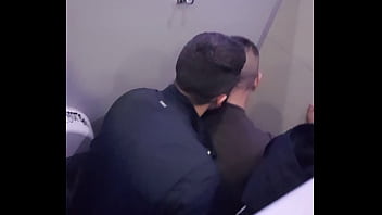 2 men having fun in a public toilet
