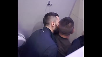 2 men having fun in a public toilet
