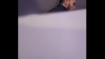2 men having fun in a public toilet
