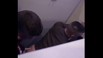 2 men having fun in a public toilet