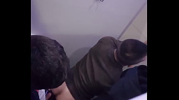 2 men having fun in a public toilet