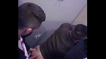 2 men having fun in a public toilet