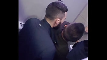 2 men having fun in a public toilet