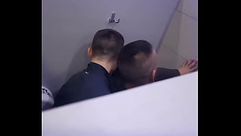 2 men having fun in a public toilet