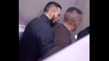 2 men having fun in a public toilet