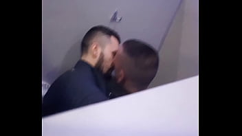 2 men having fun in a public toilet