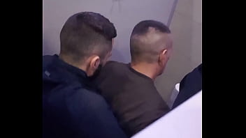 2 men having fun in a public toilet
