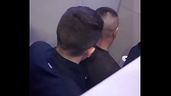2 men having fun in a public toilet