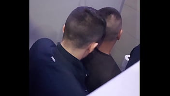 2 men having fun in a public toilet