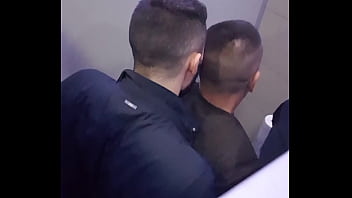 2 men having fun in a public toilet