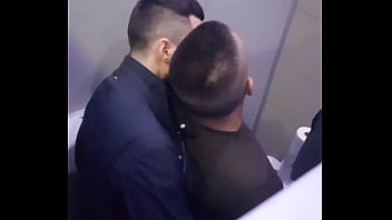 2 men having fun in a public toilet