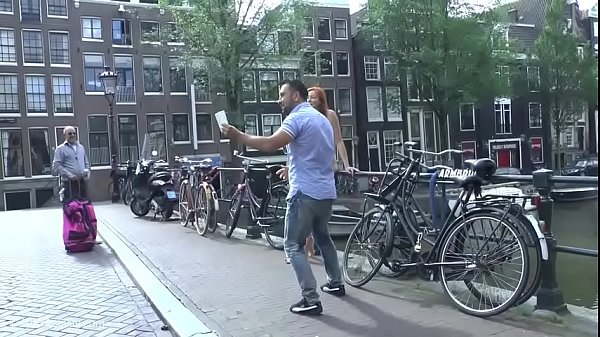 Pretty redhead walking naked in Amsterdam