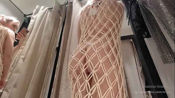 I try on clothes in fitting room with open curtain. Hotwife